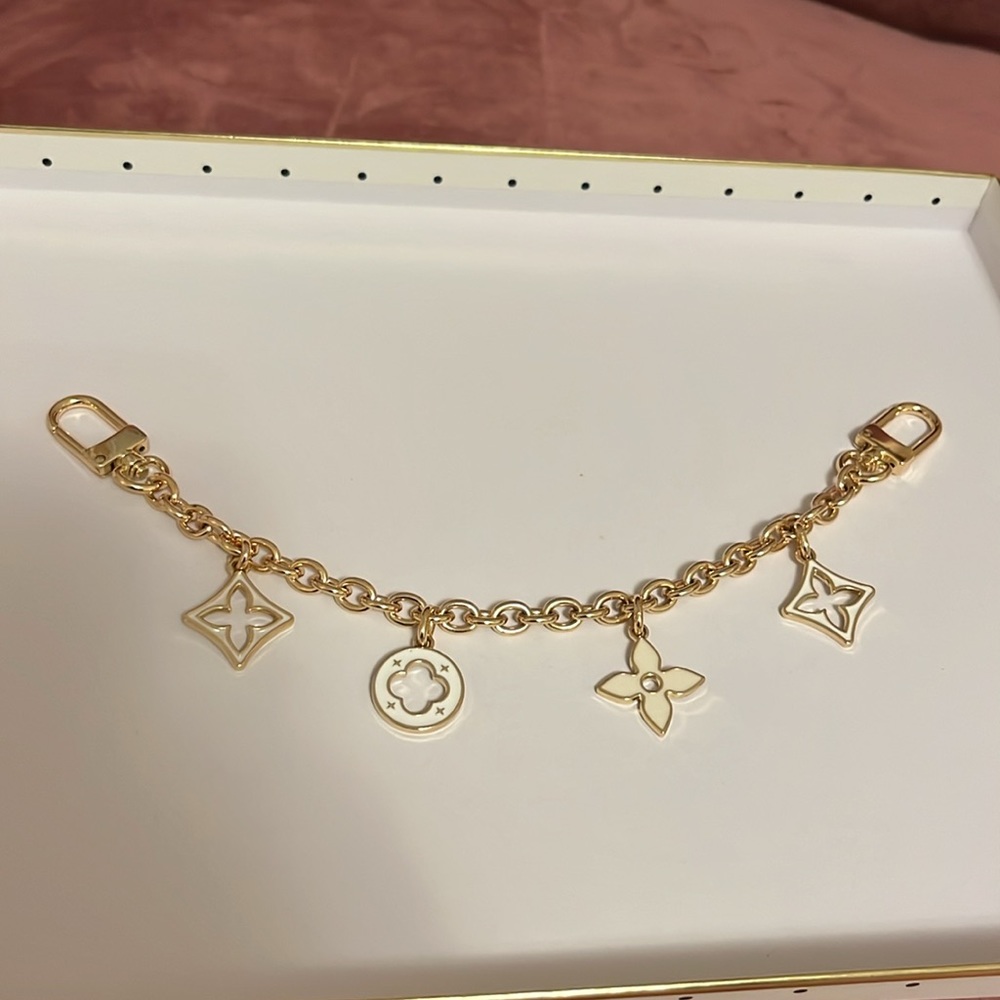 White and gold bag charm